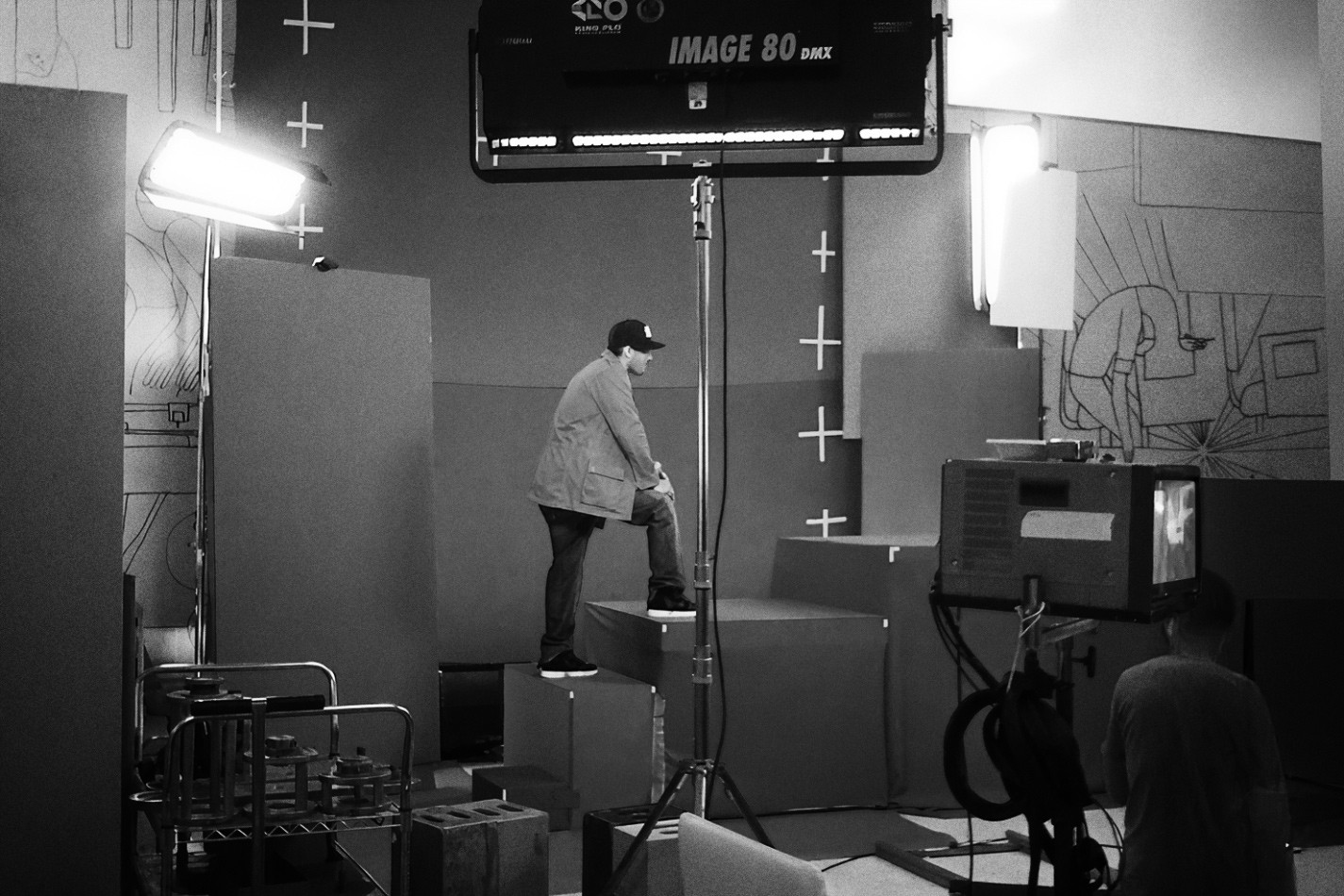 Man walking up large blocks on a makeshift stage