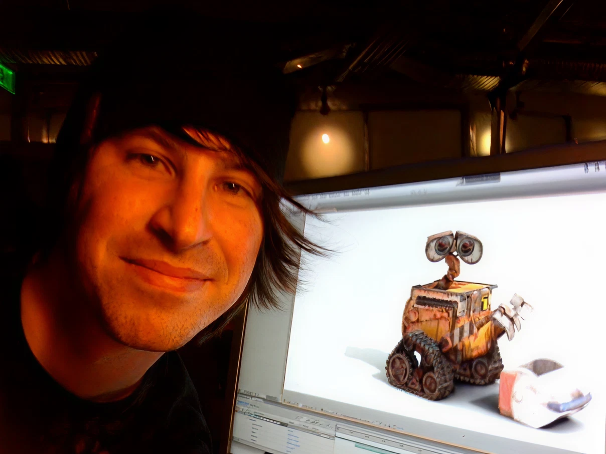 A man working on a computer with Wall-e on the screen