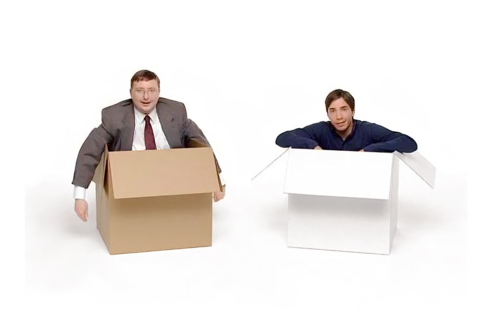 Two men sitting in boxes in a Mac vs PC ad