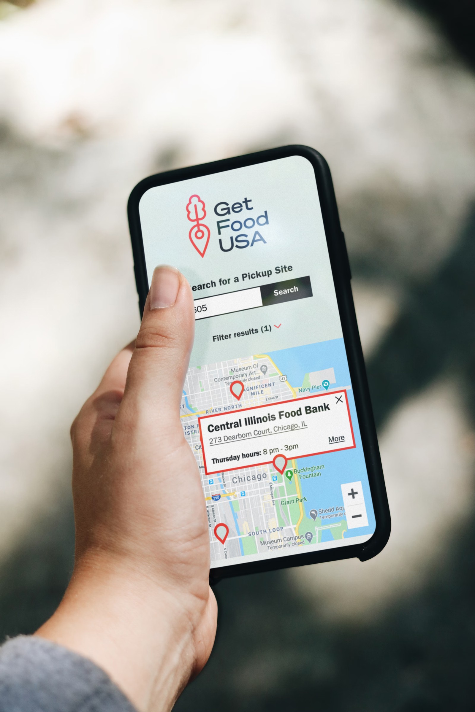 Holding a phone with a map to find food
