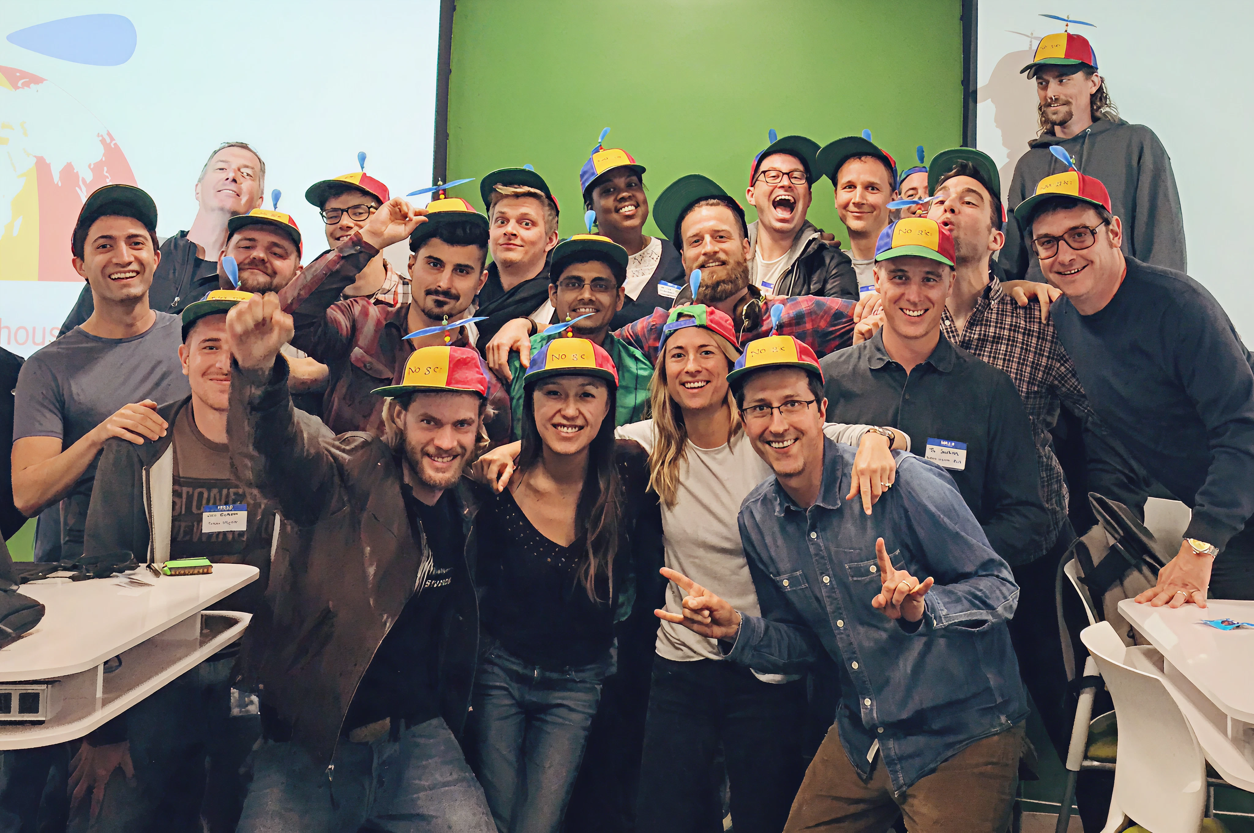 21 people in colorful Google hats celebrating